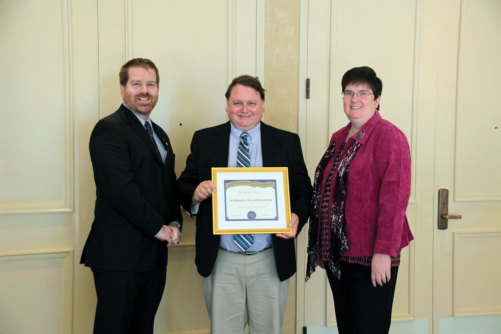 Randy booker (center) is pictured with SPS President DJ Wagner (right) and SPS Director Sean Bentley (left). Photo by Courtney Lemon. 