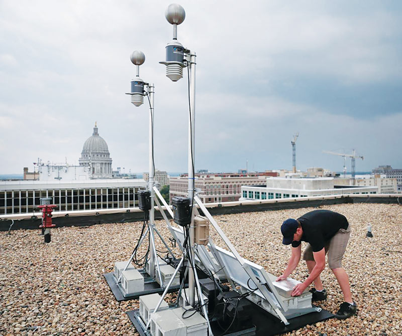 Andrew Piotrzkowski of Understory sets up the Madison startup’s weather-data monitor on the roof of the 316 Building, 316 W. Washington Ave., Madison, Wisconsin. All photos by Alex Kubicek