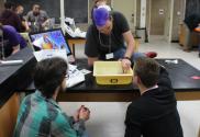 A team attempts to float pennies in their aluminum foil boat.