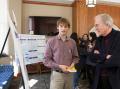 Jonathan Wheeler explains his research to then-president of Andrews University, Niels-Erik Andreasen, at a poster session in 2013. Photo by Christa McConnell.